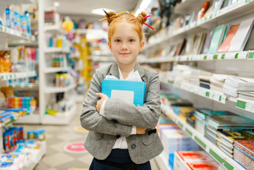 little school girl in stationery store